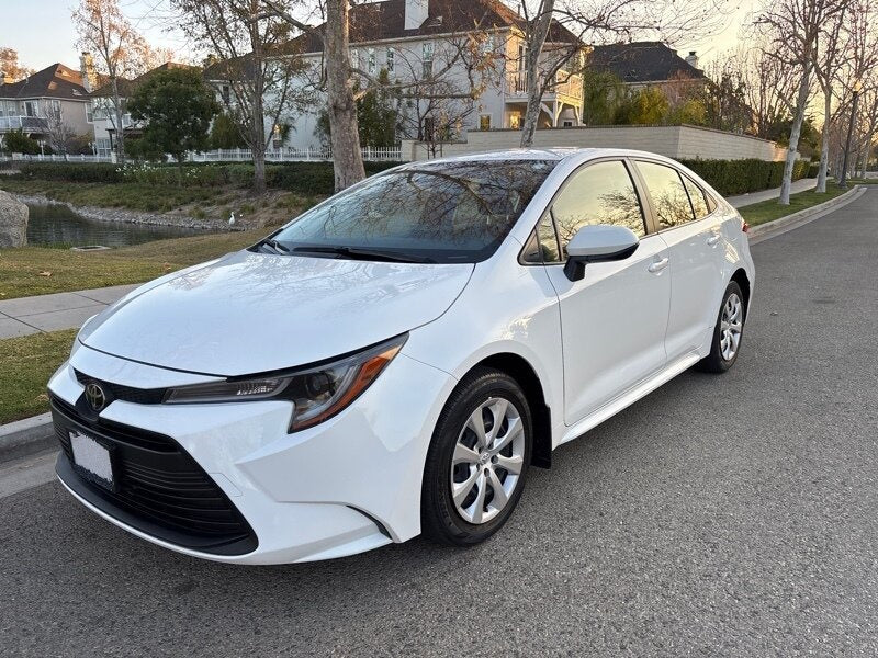 White sedan parked on a street.