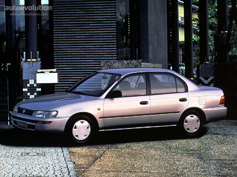 Silver sedan car parked on a city street.
