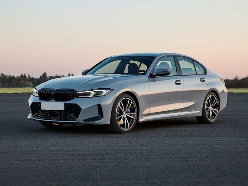 Silver BMW sedan on asphalt.