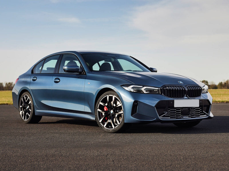 Blue BMW sedan on a paved road.