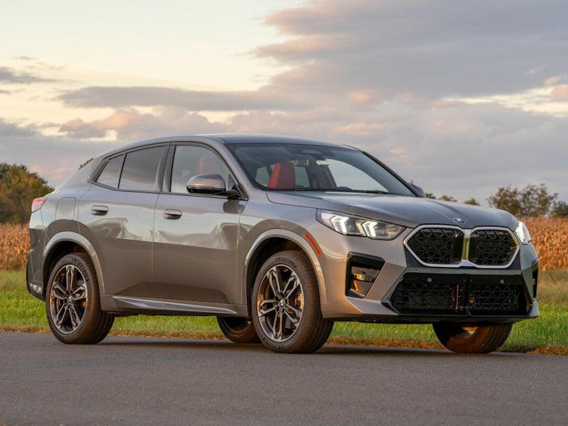 Gray BMW SUV parked on a road.