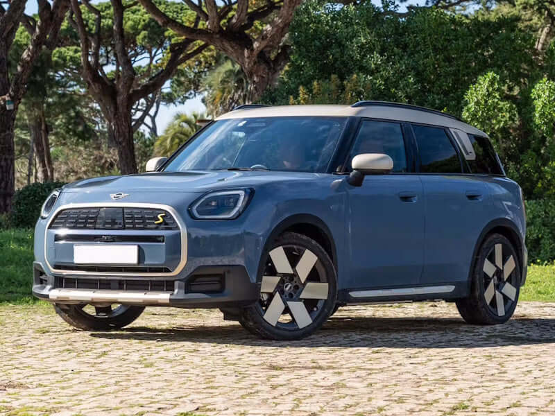 Blue Mini Cooper SUV parked outdoors.