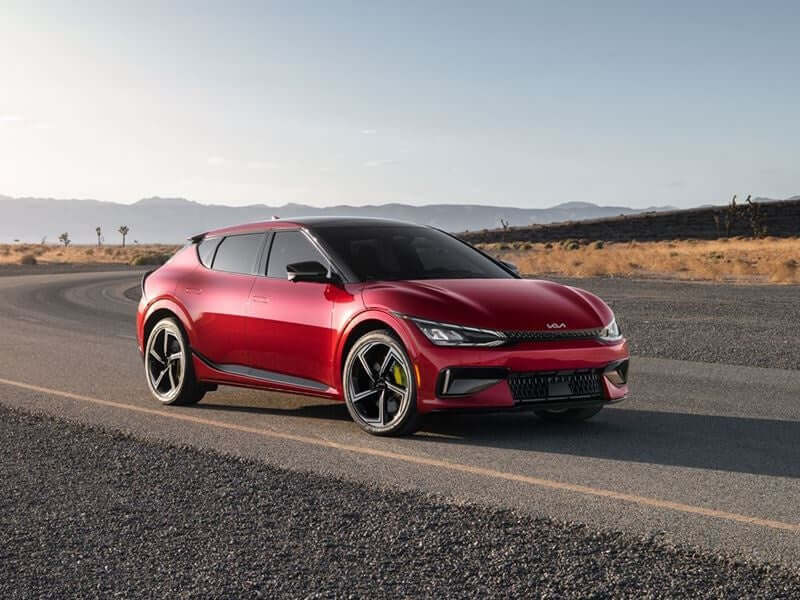 Red Kia EV6 on a road.